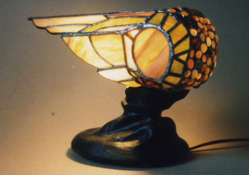 Lamp#1 This Stained Glass lamp is my first lamp design. I sculpted the base out of clay and cast it in hydrocal. The round jewels on the lamp are polished garnets.